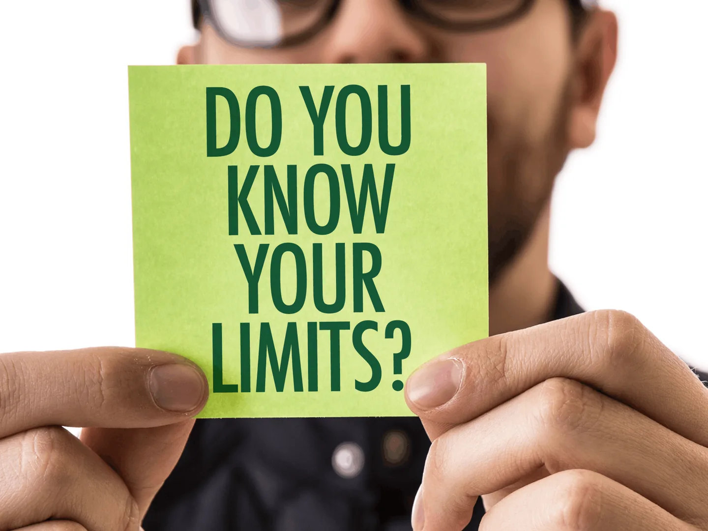 A person holding a card that reads: do you know your limits?